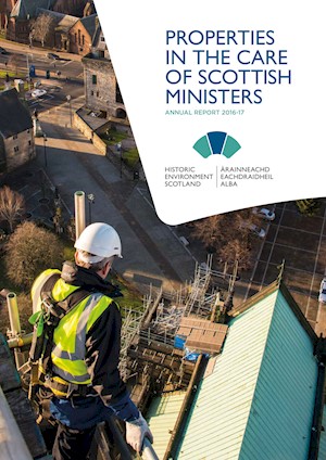 A photograph of a man in a high visibility jacket, looking over scaffolding to the roof of a building. The title is "Properties in the Care of Scottish Ministers: Annual Report 2016-17"