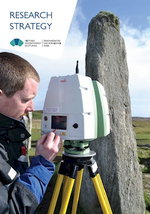 HES employee scanning a standing stone